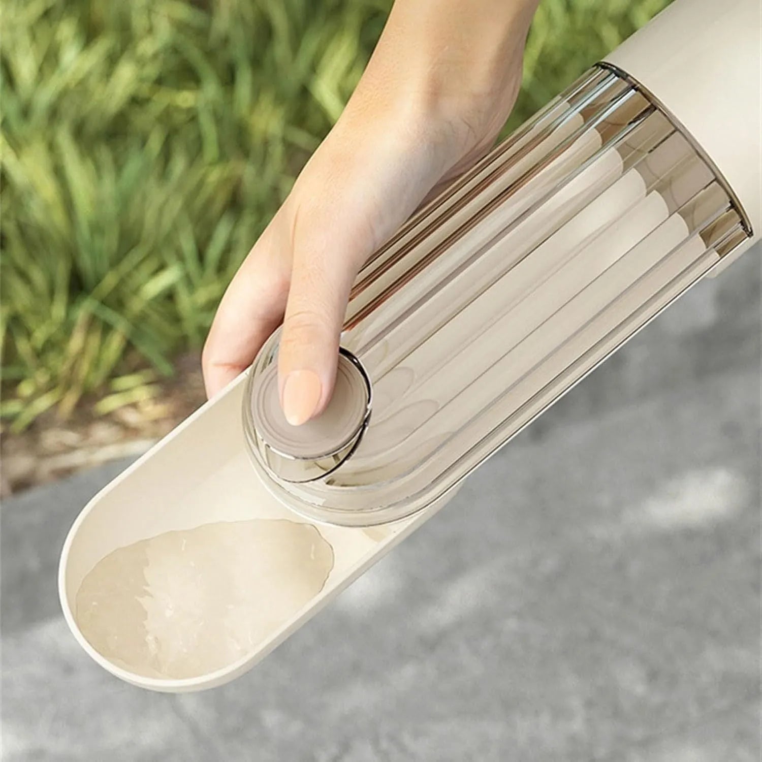 Beige foldable dog water bottle with a press-button dispenser and a small food container at the base.