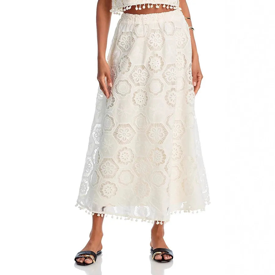 White women's two-piece suit with sleeveless top, long skirt, and embroidery detail.