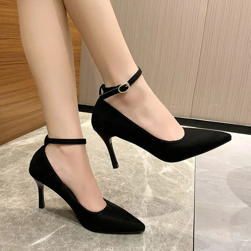 Women's black stiletto heel pump shoe with a buckle detail on the upper
