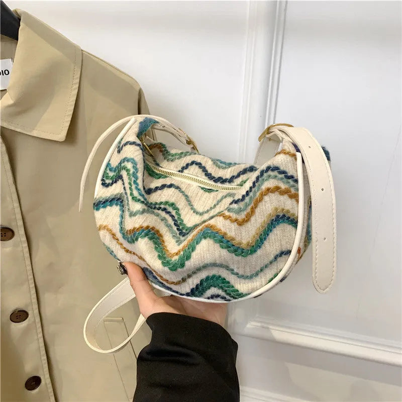 Women's woven straw crossbody bag showing internal phone pocket and file compartment