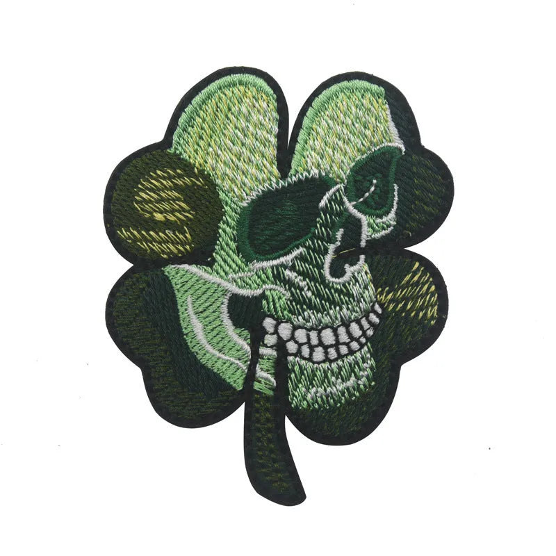 Outdoor embroidered fabric badge with Velcro strip backing on a green clover design.