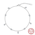 Women's silver anklet with small geometric zirconium pendant in gold tone.