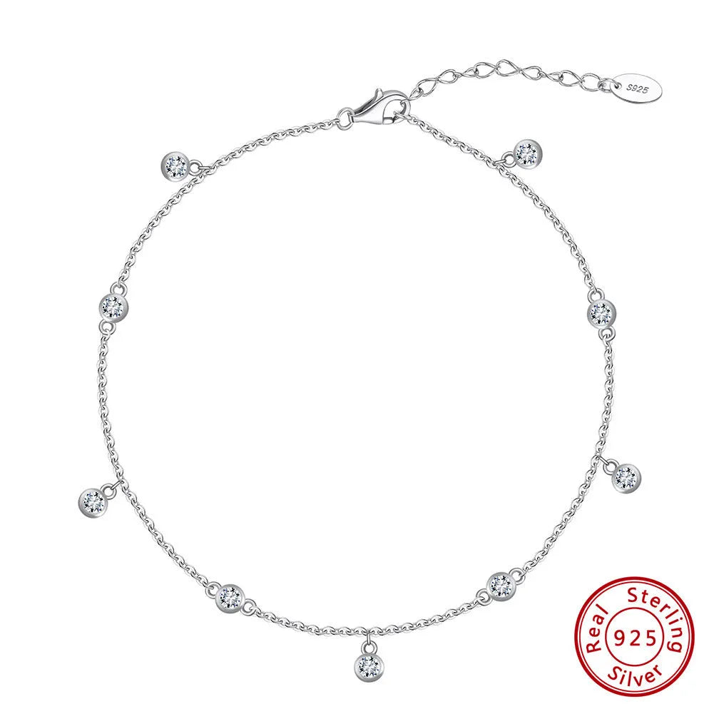 Women's silver anklet with small geometric zirconium pendant in gold tone.