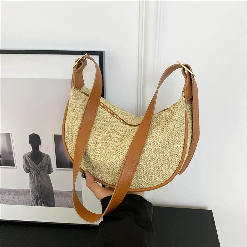 Women's woven straw crossbody bag showing internal phone pocket and file compartment