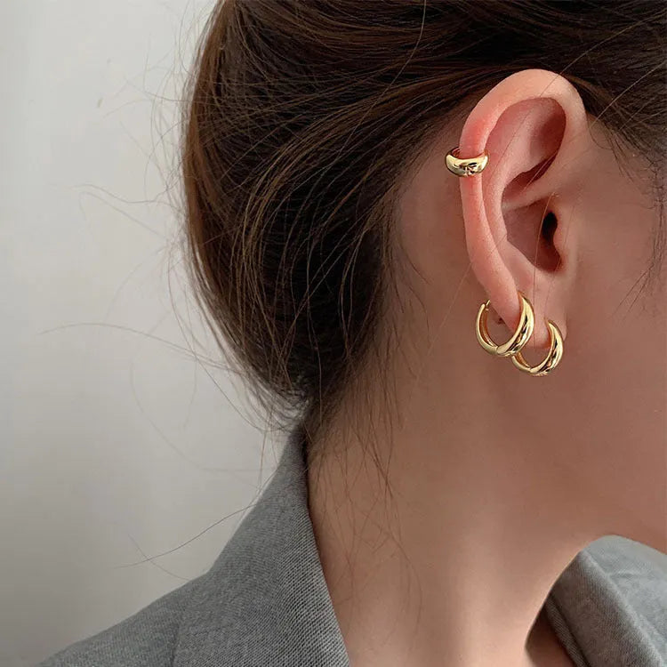 Women's minimalist copper water drop earrings in gold or silver, shown in large, medium, and small sizes.