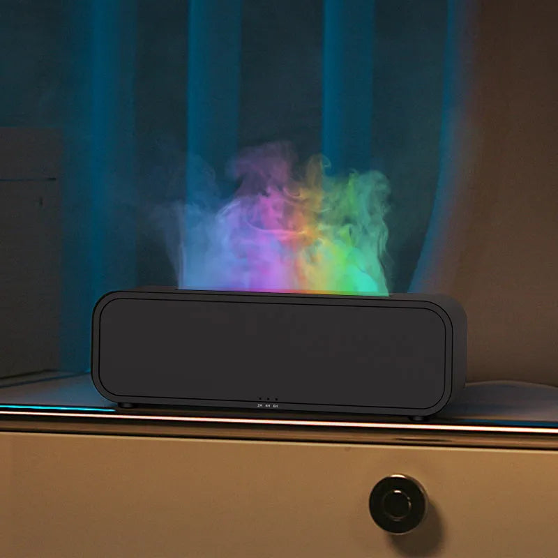 Black and white USB essential oil aroma diffuser with colour-changing light and remote control on a desk