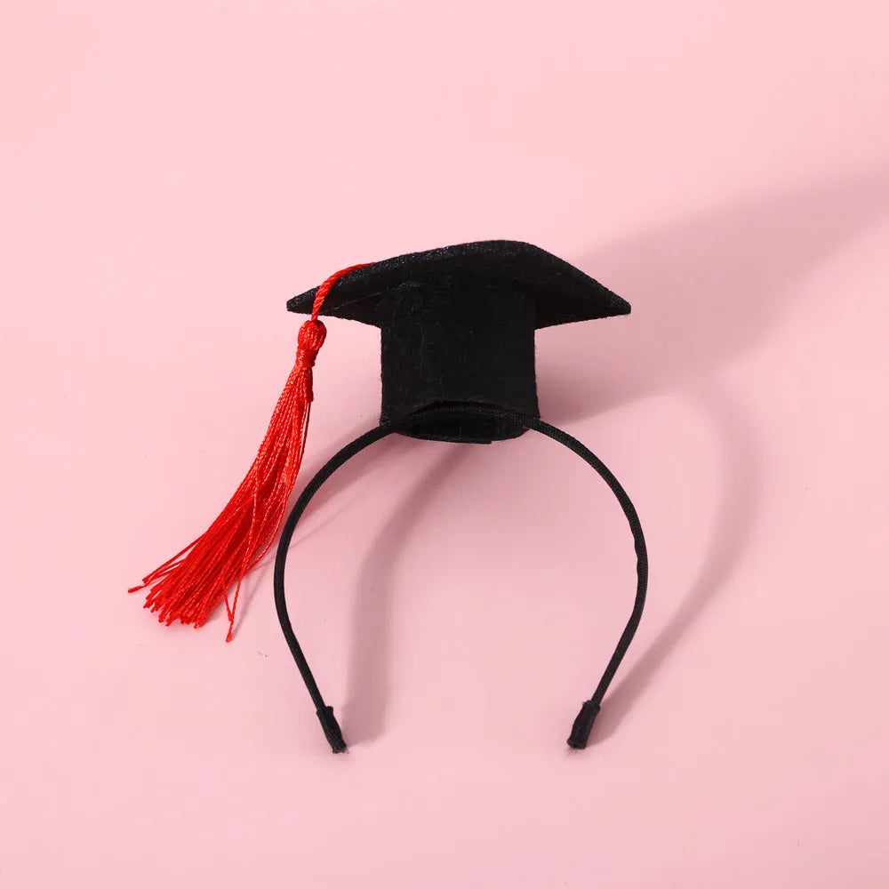 Small pet wearing an elastic wool felt hair band and matching doctor's degree bow tie.
