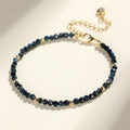 Close-up of a women's blue tourmaline bracelet with 3mm beads and gold spacer beads.
