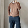 Man wearing a loose grey rabbit fur blend knitted pullover sweater, casual autumn style.