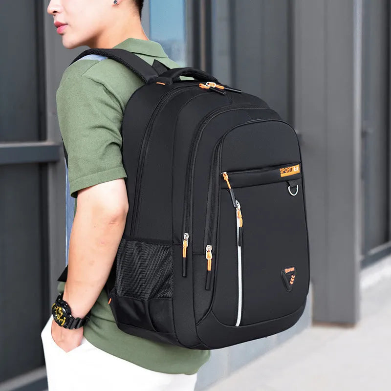 Men's large Oxford cloth schoolbag in black with letter pattern, showing air pillow belt and splicing detail.