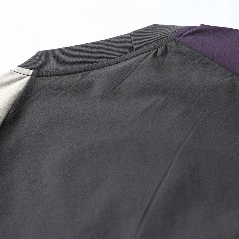 Dark grey loose-fit t-shirt with contrast colour raglan short sleeves on a hanger.