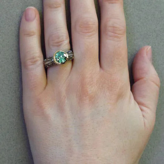 Gold-plated flower-shaped ring with vintage gemstone details in green silver colour