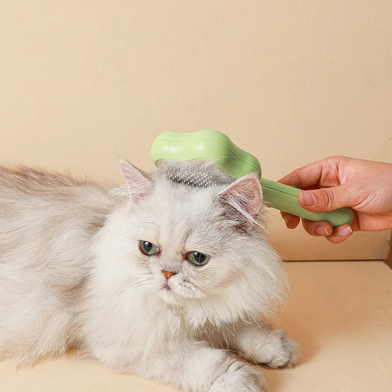 Self-cleaning stainless steel cat comb in green colour measuring 20cm long by 9.5cm wide