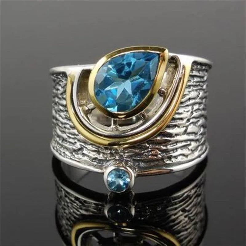 Blue zircon Chinese style drop shape alloy ring with rhinestone detailing on silver-toned band
