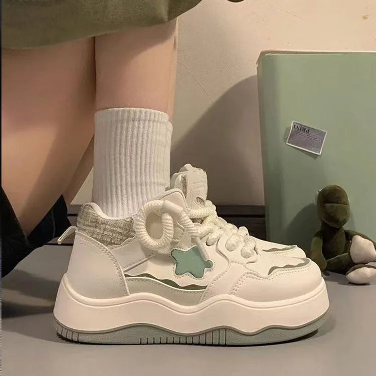 Women's green platform sneakers with patent leather details and rubber sole