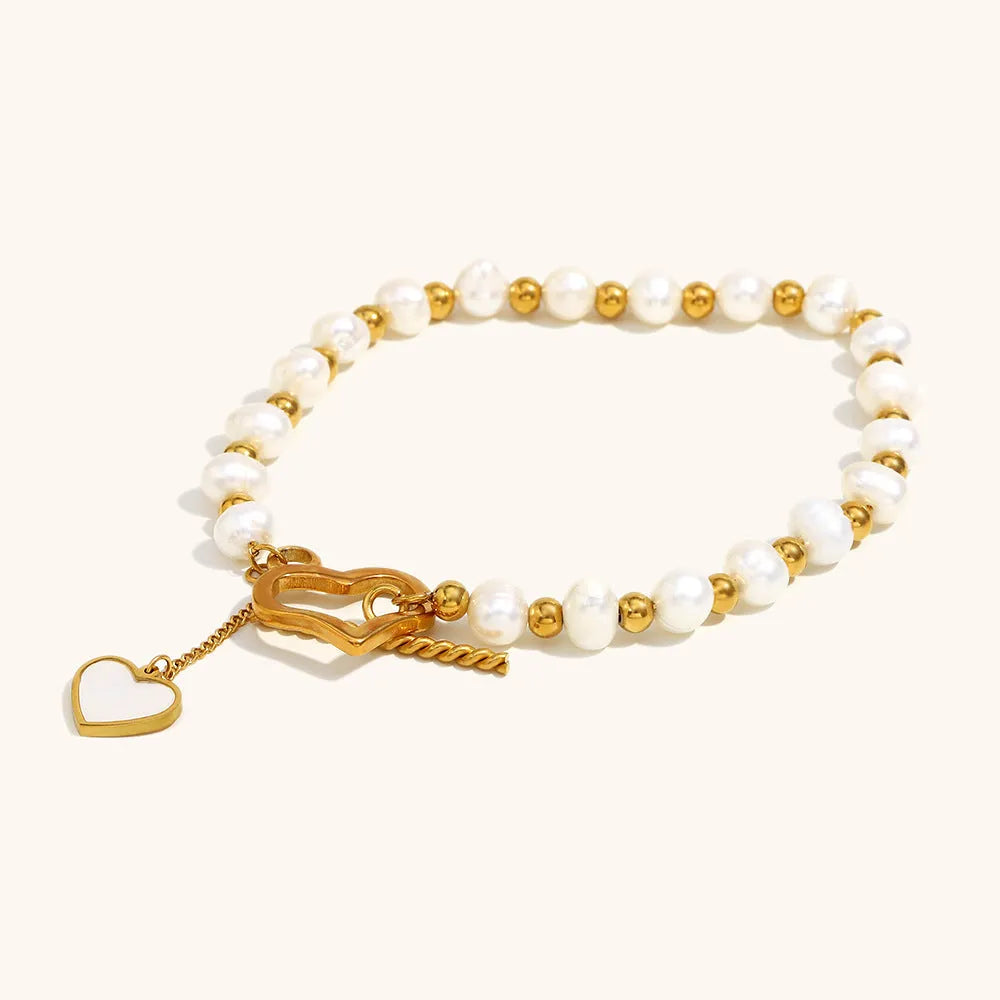 Gold pearl heart-shaped buckle bracelet on display