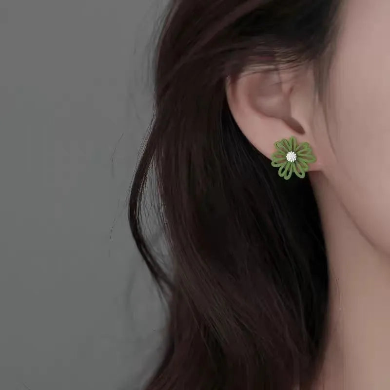 Cartoon style flower stud earrings made from alloy in blue and orange two-tone colours.