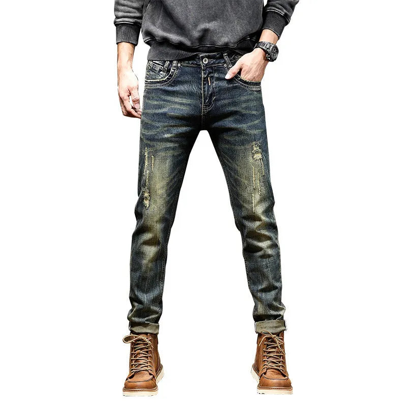 Men's skinny fit stretch denim jeans in a retro colour with a zip fly, laid flat.
