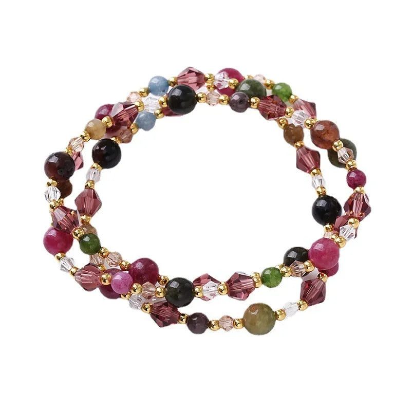 Women's handcrafted three-ring crystal bracelet with tourmaline, strawberry quartz, and amethyst beads on adjustable cord