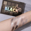 Open 15-colour eye shadow palette showing pans of brown, blue, and grey matte and shimmer shades.