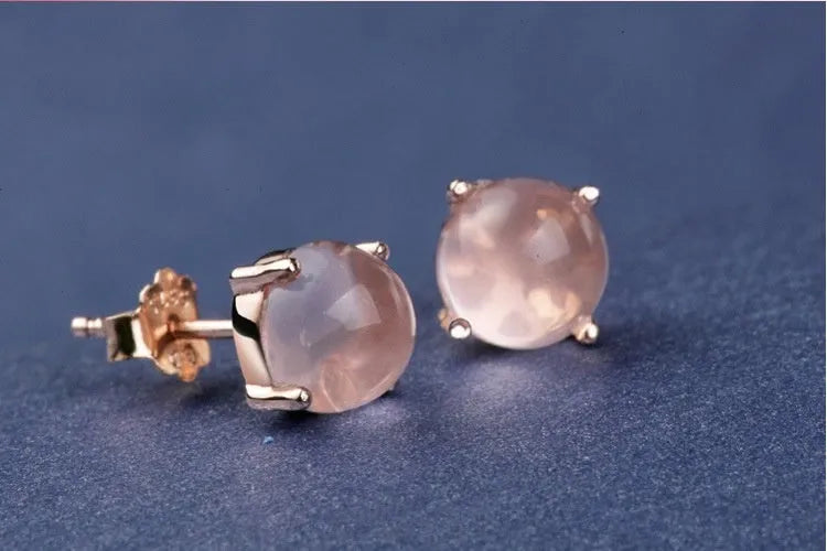 Rose gold drop shape stud earrings with synthetic ross quartz crystal inlay detail