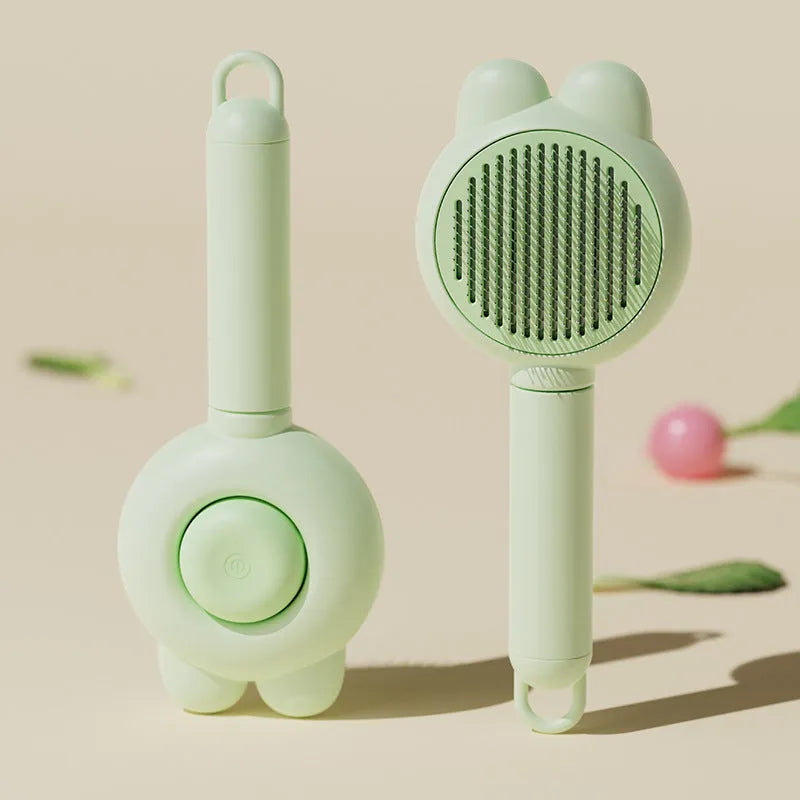 Green self-cleaning pet grooming brush with a stainless steel comb and a comfort-grip handle.