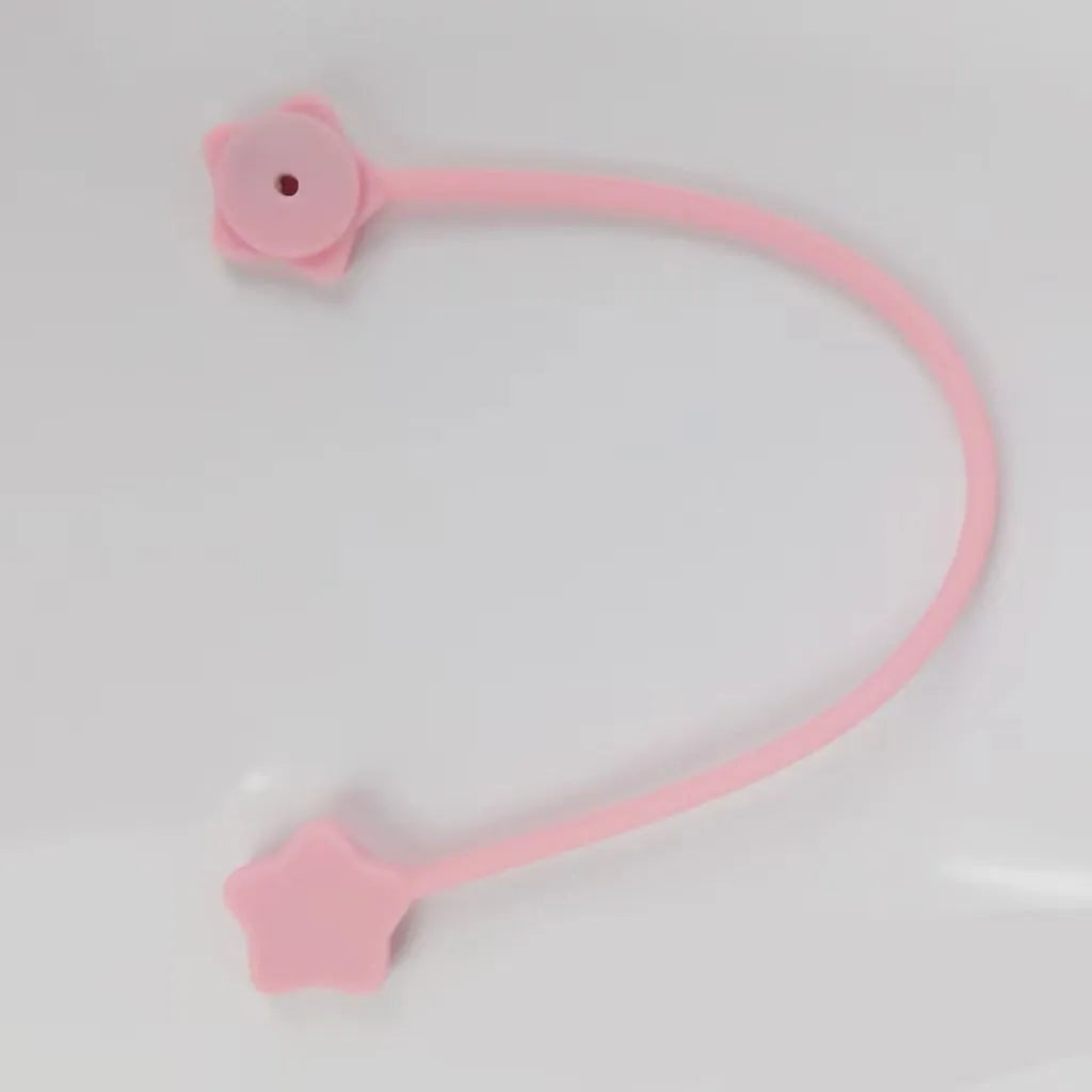 Purple silicone star-shaped magnet winder for clipping onto and organising headphone or phone charging cables.