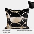 Black and gold abstract patterned flannel cushion on a sofa, showing removable cover.