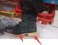 Women's black cross strap knight boots made from PU leather, showing the knee-high design and strap detail.