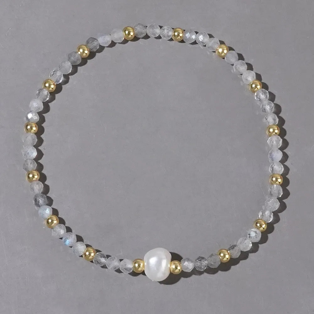 A geometric natural stone bracelet with an ellipse detail, shown in one of fifteen available colour options.