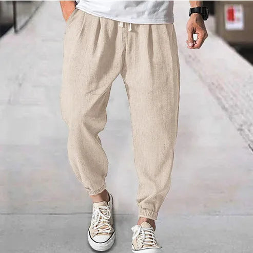 Men's loose casual cotton trousers with an elasticated ankle band in light green.