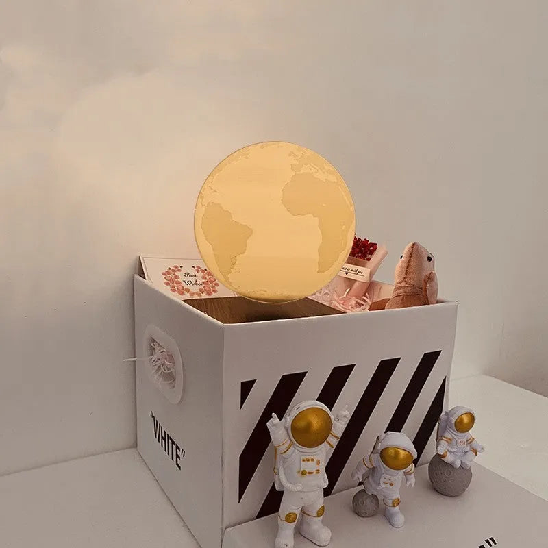 Maglev floating planet night light with LED glow, astronaut figurines, and USB cable.