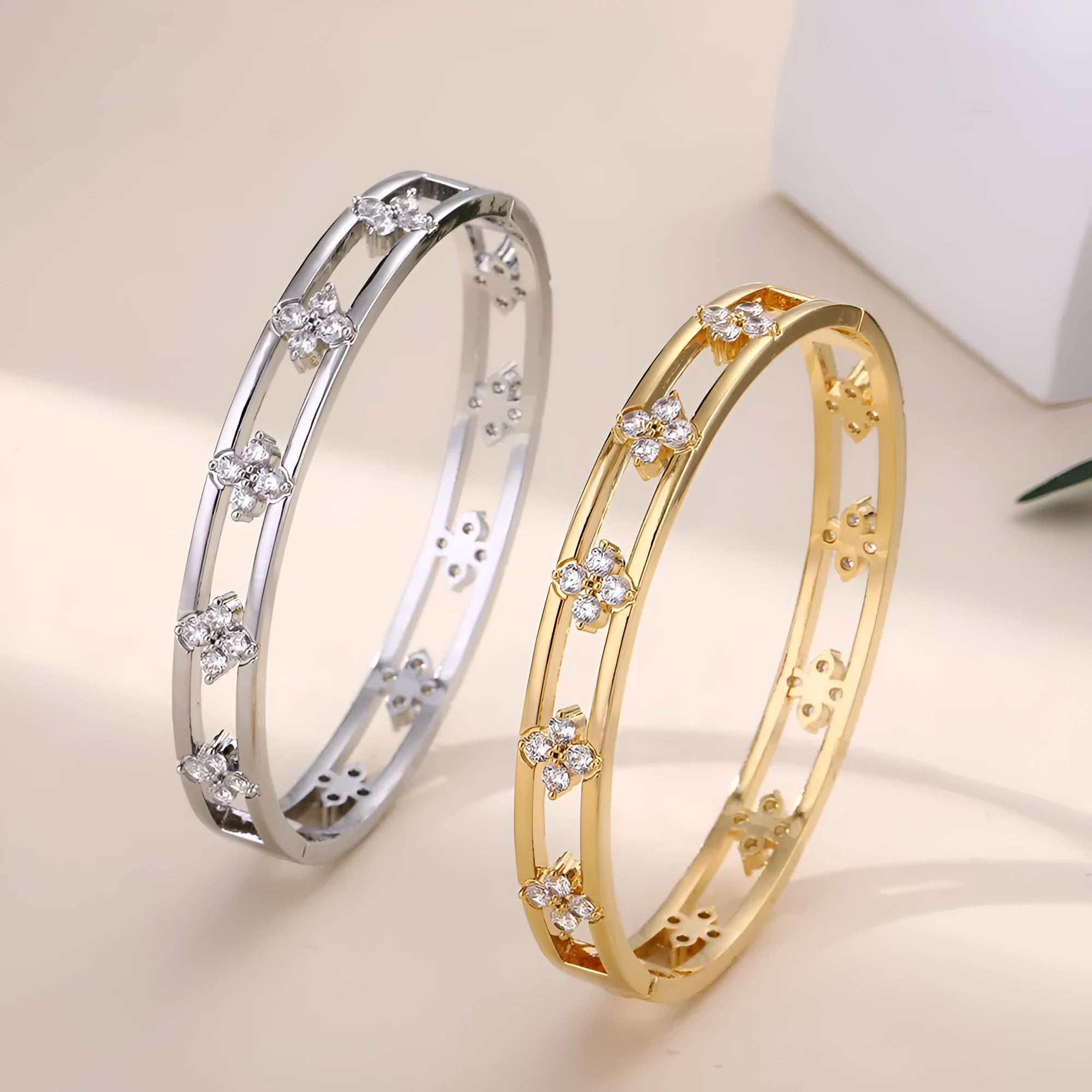 Women's hollow bracelet with four-leaf clover charm and zircon stones in gold or silver tone