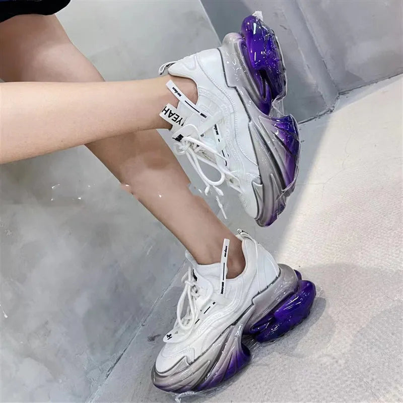 Women's green leather sports shoes with a thick clear jelly sole and white cross-tie laces.