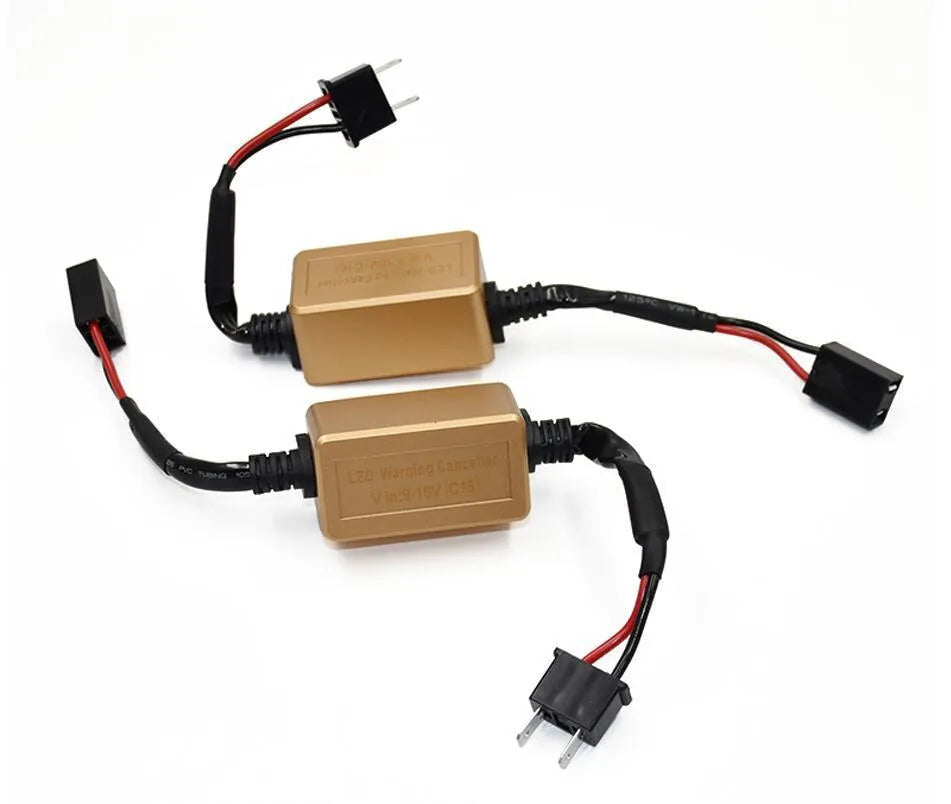 Black alloy LED Canbus decoder for H4 H7 H11 car headlight bulbs on a white background.