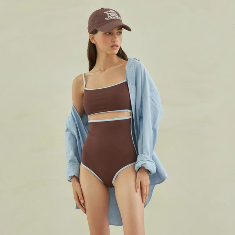 Brown triangle one-piece swimsuit for women on a hanger.