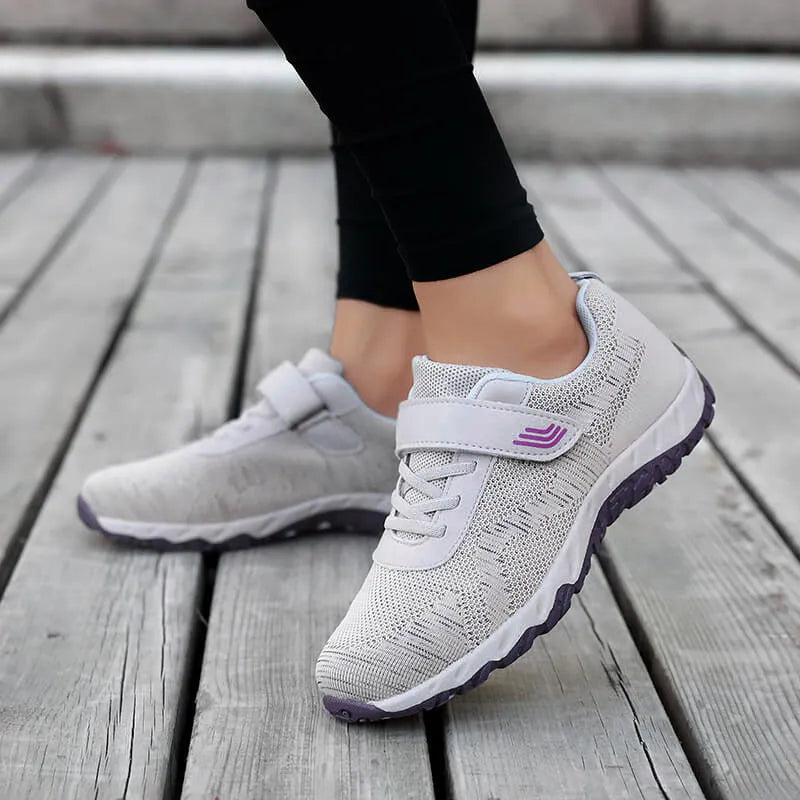 Women's low-top wedge sneaker in grey purple with mesh upper and Velcro strap.