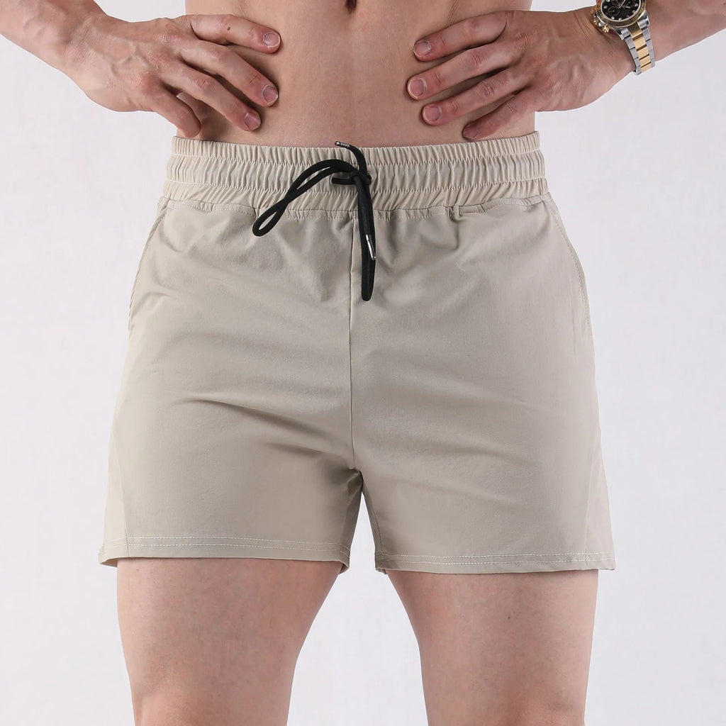 Men's thin grey polyester basketball shorts with an elastic waistband on a plain background