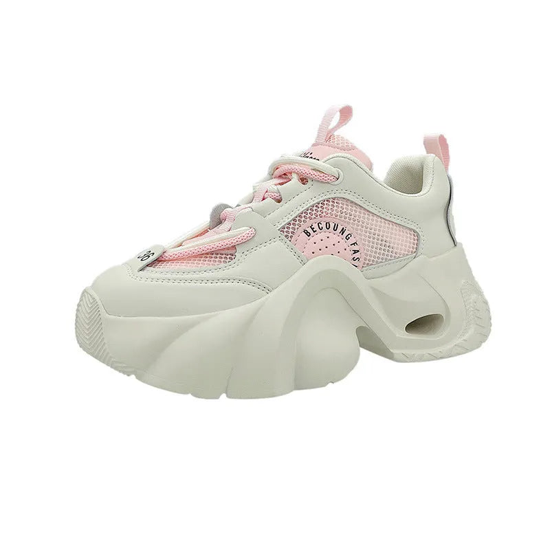 Women's pink sneakers with cross straps and a thick white platform sole.