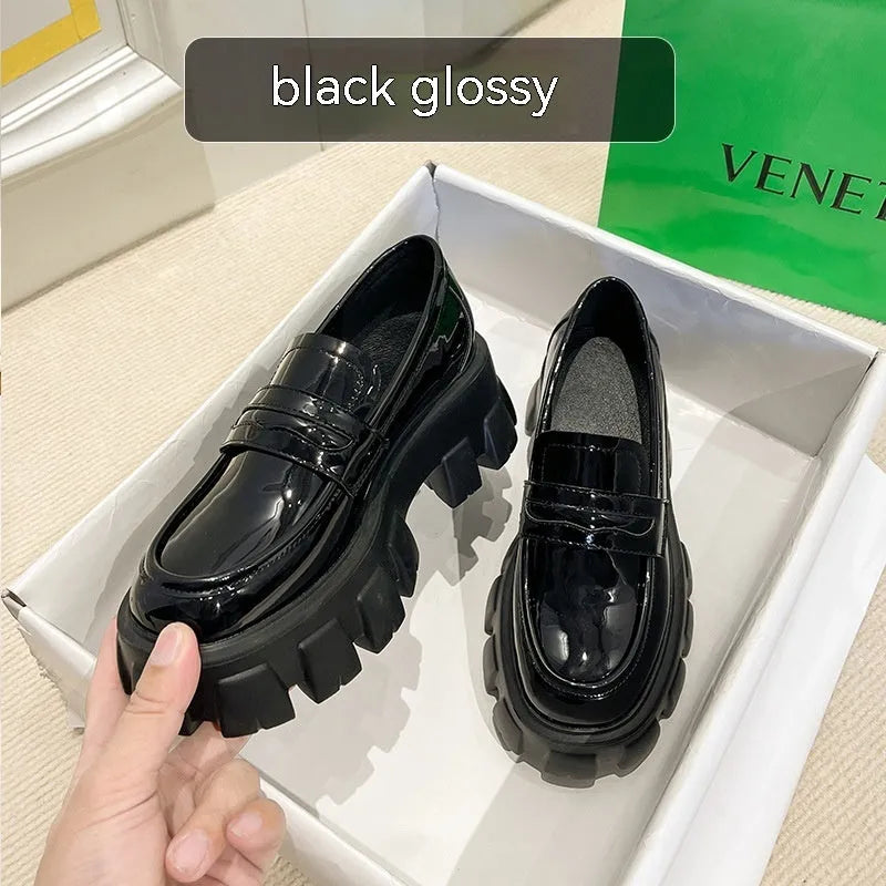 A pair of wide fit leather loafers in a slip-on style with a rubber sole, shown in a choice of finishes.