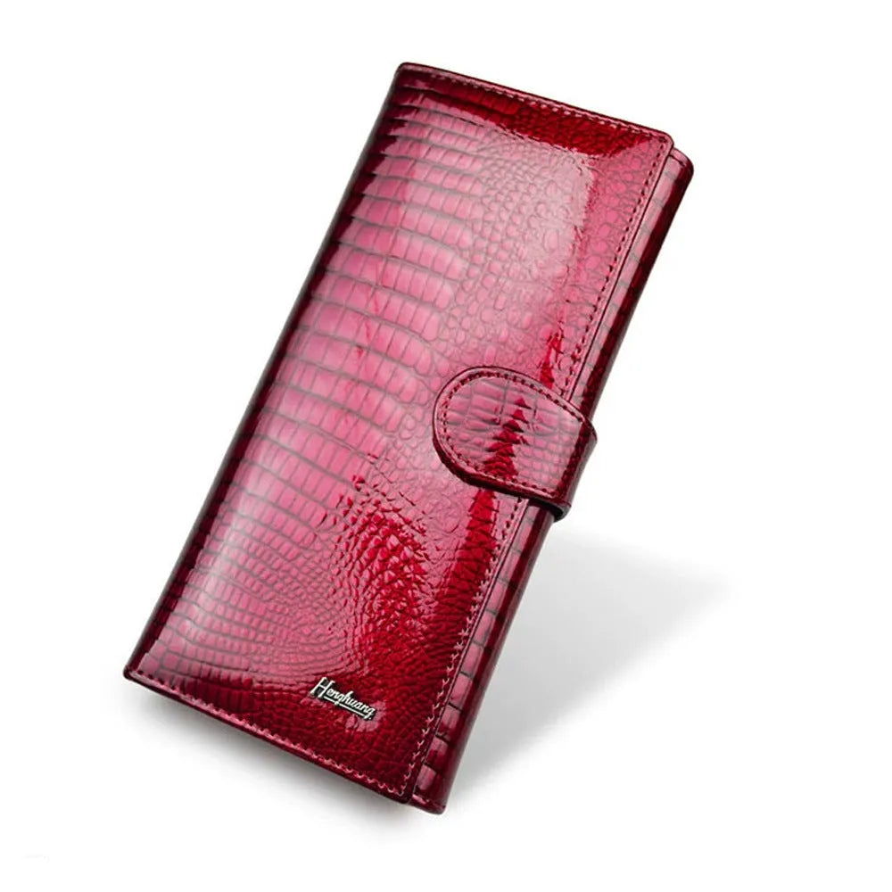 Women's red leather coin purse with a textured crocodile pattern, shown open to reveal pigskin lining.