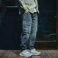 Blue men's loose straight-leg stretch denim trousers on a hanger