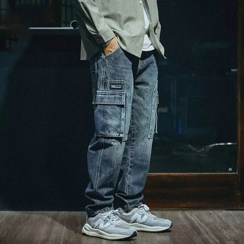 Blue men's loose straight-leg stretch denim trousers on a hanger