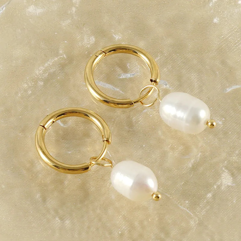 Gold geometric drop earrings for women with a pearl detail on a stainless steel base.