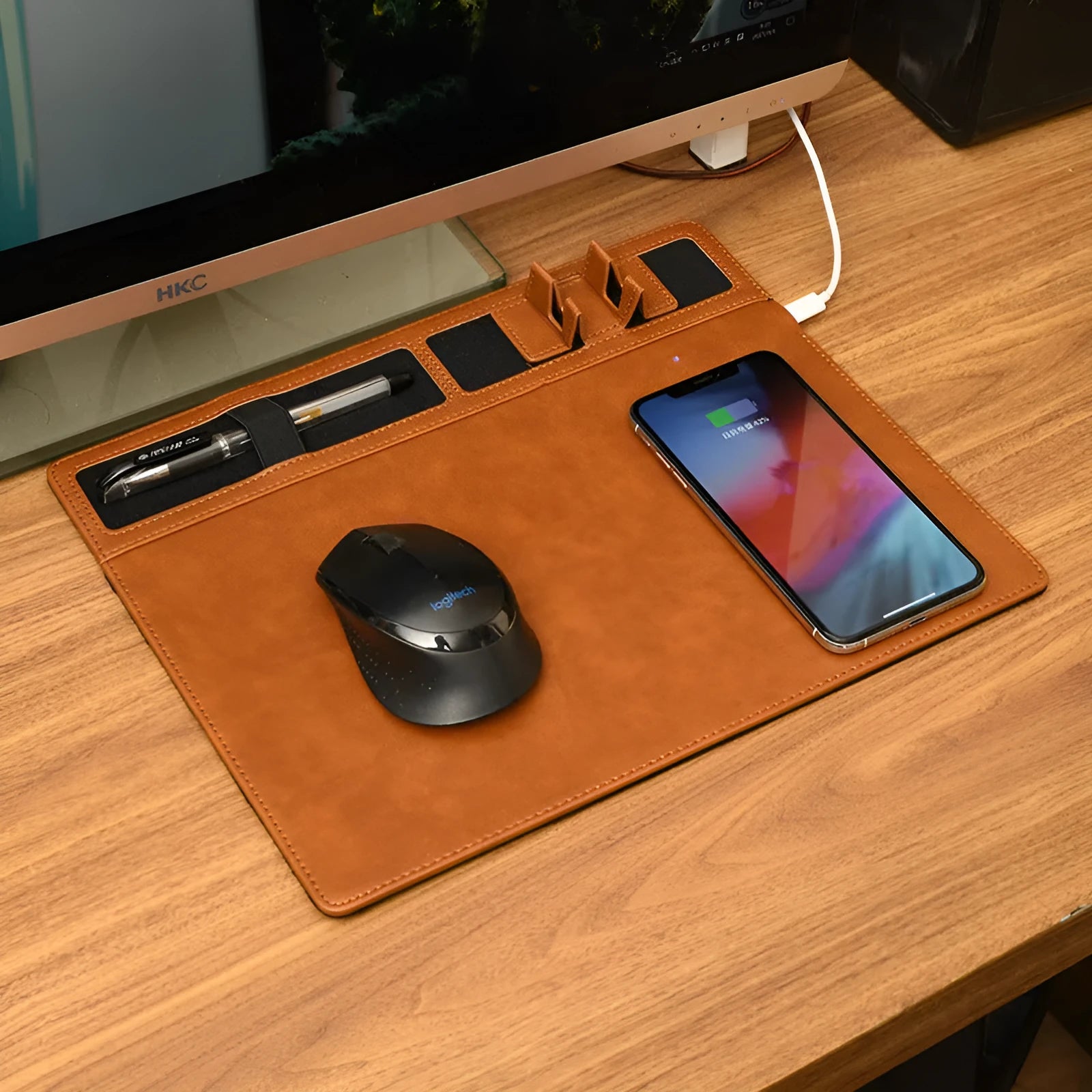 Pink wireless charging mouse pad with integrated phone holder on a desk, showing 320 x 260 mm size.