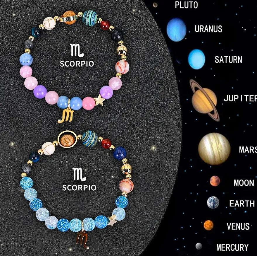 Two adjustable natural stone beaded bracelets with metal zodiac sign charms on a wooden surface.