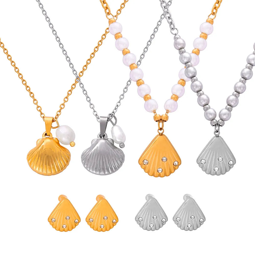 Gold tone women's necklace with shell pendant and freshwater pearl bead on O-chain.