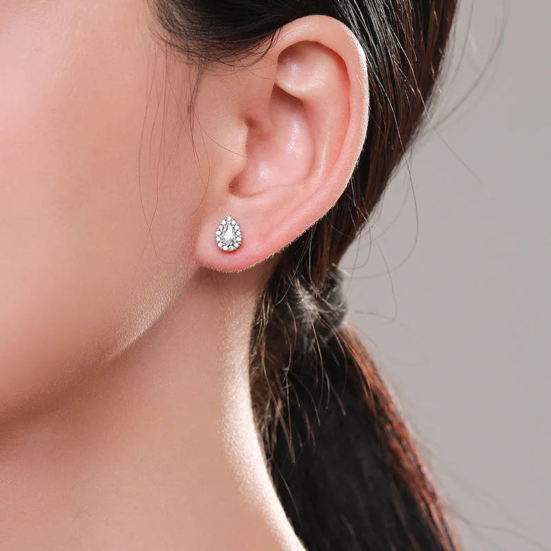 A pair of women's silver drop-shaped ear studs made from 925 sterling silver.