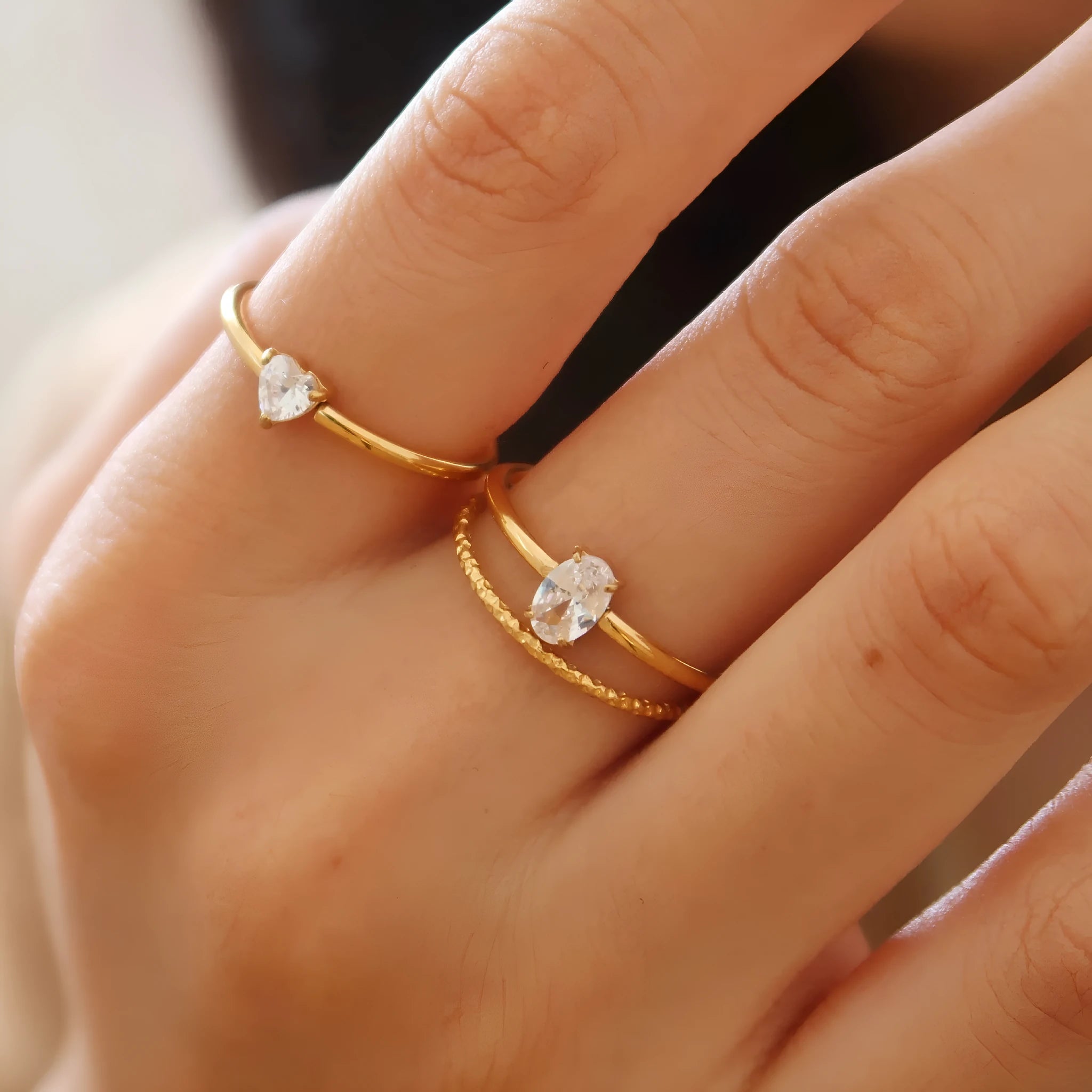 Golden stainless steel ring showing heart and oval love symbol designs with size options from 5 to 8