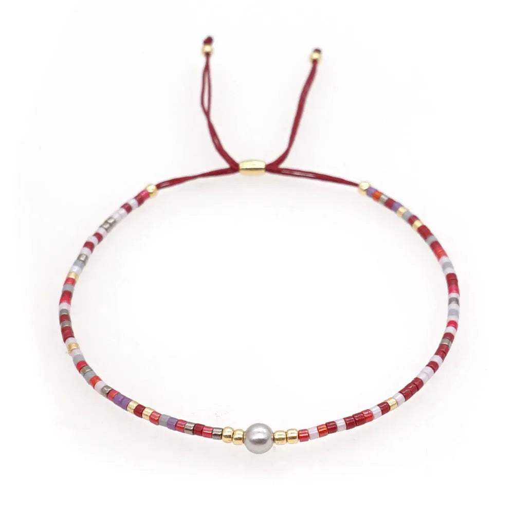 A colourful Bohemian style beaded bracelet with semi-precious stone and glass beads on an adjustable strap.